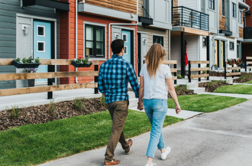 A young couple strolls along the sidewalk in a new Genstar community.